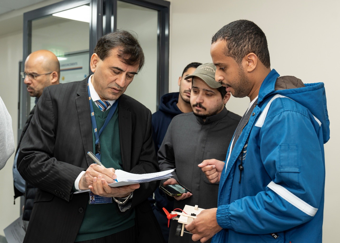 PBL > PBL Center and AI > Fig. 1-a Fig. 1-a: Faculty member from Mechanical Engineering Department evaluating student’s prototypes enrolled in 21SMCE423/424: Fluid and electrical drive systems/Automation and sensors in fluid systems/ (PBL course), Spring 2024–2025.