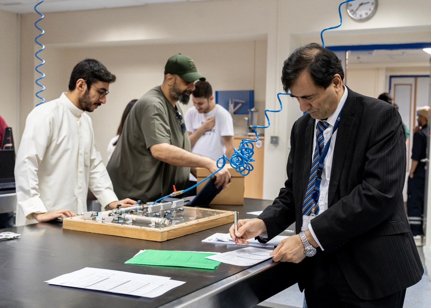PBL > PBL Center and AI > Fig. 1-b Fig. 1-b: Faculty member from Mechanical Engineering Department evaluating student’s prototypes enrolled in 21SMCE423/424: Fluid and electrical drive systems/Automation and sensors in fluid systems/ (PBL course), Spring 2024–2025.